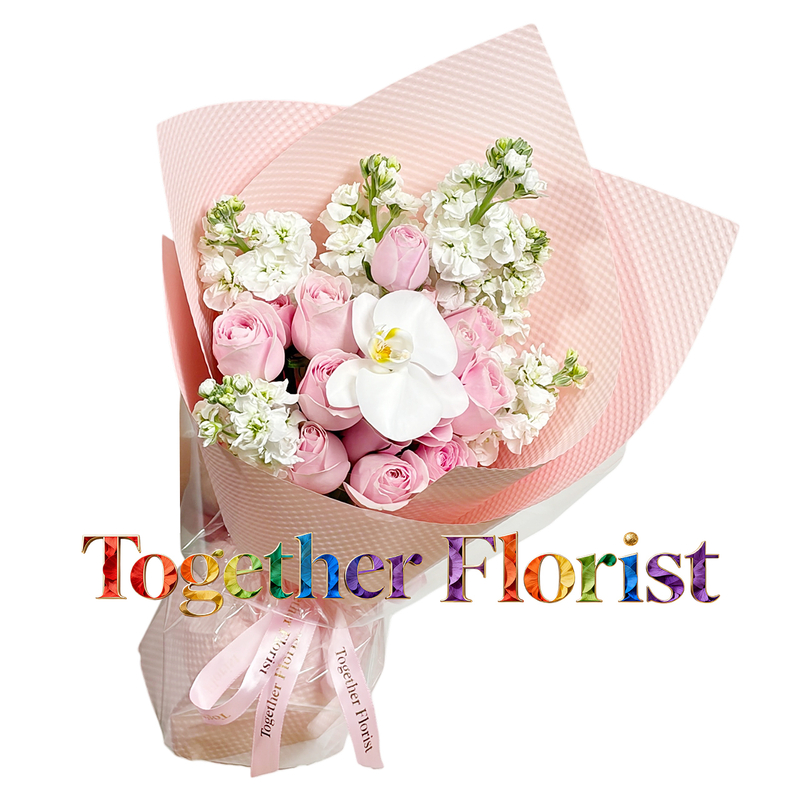 A bouquet of pink roses mixed with orchids and violets