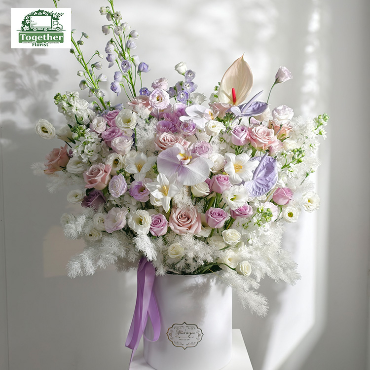 Phalaenopsis mixed with tulips and roses in a bucket fl0000-XH0106